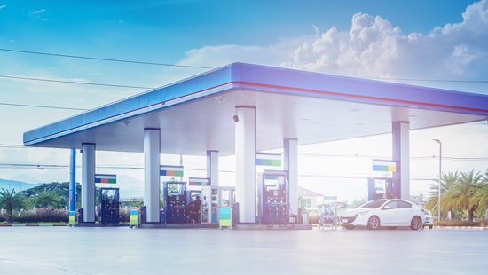 Convenience store gas pumps with cars.