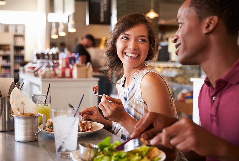 Two people eating in a restaurant